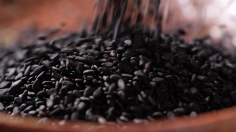 Black sesame seed falling in slow motion