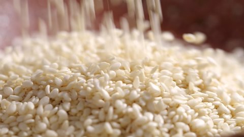 White sesame seed falling in slow motion