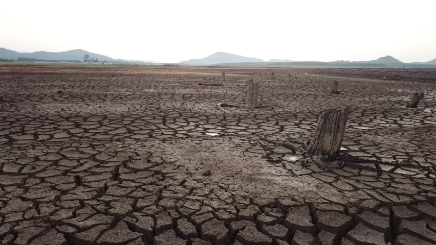 Global warming concept . Dry cracks in the land, serious water shortages. Drought concept. Royalty-Free Stock Footage #1061457406
