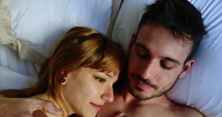 Young couple relaxing in bed and having fun. Concept about couples, making love, and stying home. Lifestyle moments from coronavirus lockdown | Shutterstock HD Video #1061461669