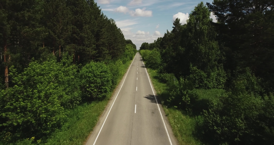 Empty road endless asphalt straight freeway in green dense forest / Aerial top down view, Highway trip without cars at summer sunset | Shutterstock HD Video #1061464057