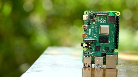 Raspberry Pi 4 on a Wooden Table Panning from Right to Left, this is a 4K footage taken Outdoor in daylight.