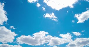 Time lapse of white clouds moving on blue sky with sun light. Time lapse 4K clip