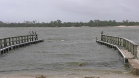 Strong waves hit walkways during a tropical storm in Indian pass bay. High quality 4k footage