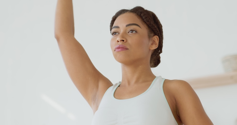 Active lifestyle. Close up below portrait of african american lady in sportswear exercising her arms at home, slow motion Royalty-Free Stock Footage #1061475076