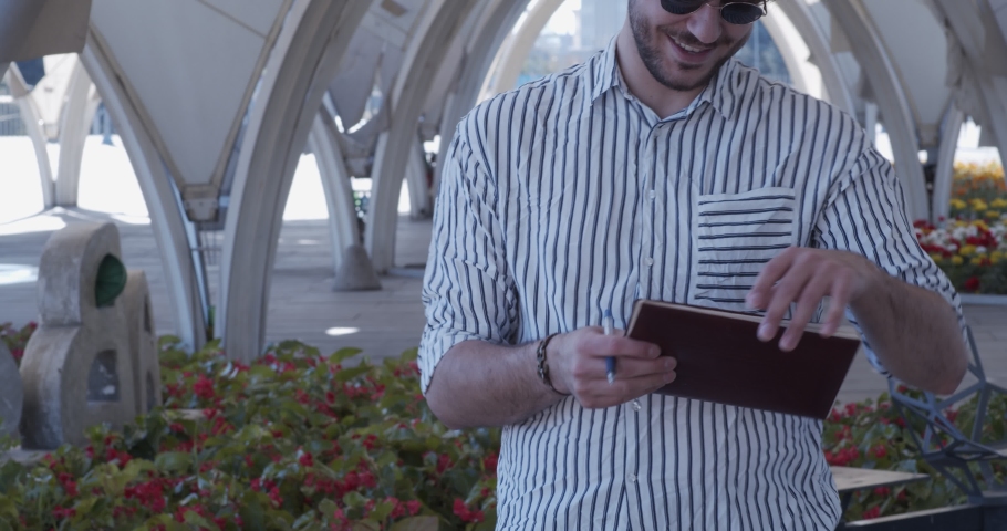Businessman working remotely in the park, practicing social distance