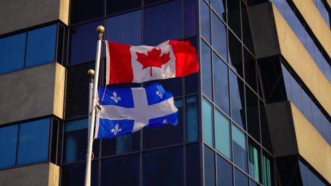 Cinematic Gimbal Shot of Quebec & Canadian Flags During Cold Autumn Day