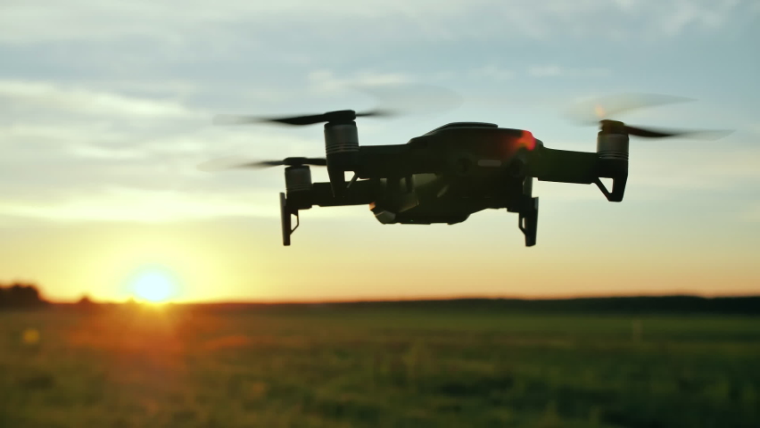 The drone hovers in flight at sunset. Royalty-Free Stock Footage #1061475697