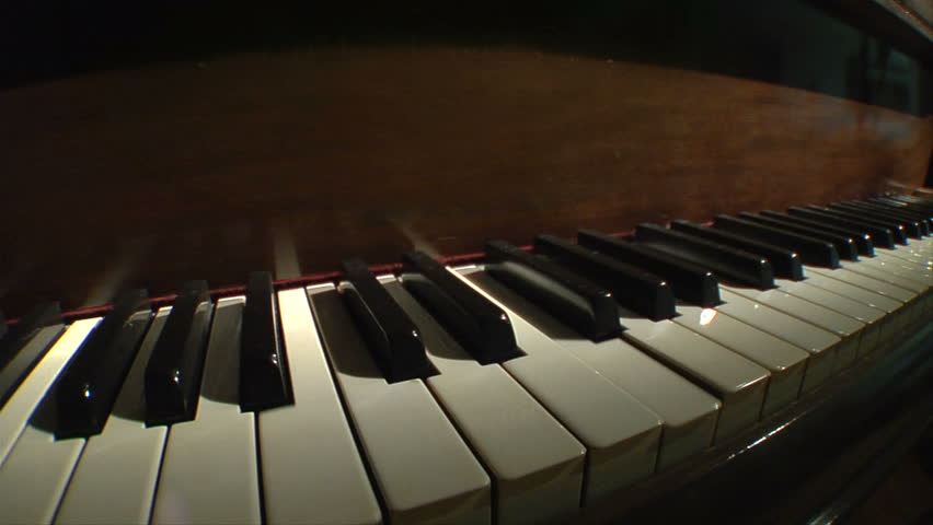 Piano keys on a grand piano close up perspective shot