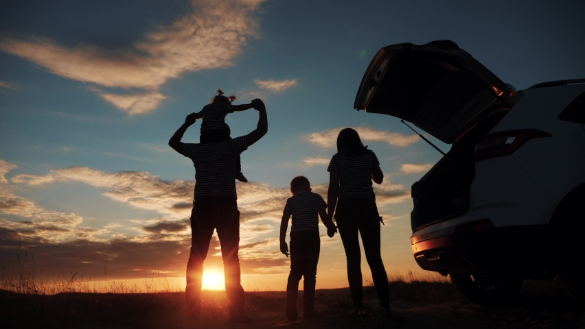 happy family children kid together standing next to car watching the sunset silhouette in park. family travel dream concept. happy family stand with sunlight their backs watching journey in the park Royalty-Free Stock Footage #1061479786