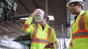 Factory worker warn coworker about safety and give hardhat to him . Injury prevention and safety first concept . - Powered by Shutterstock - Get 15% off with code: PIKWIZARD15