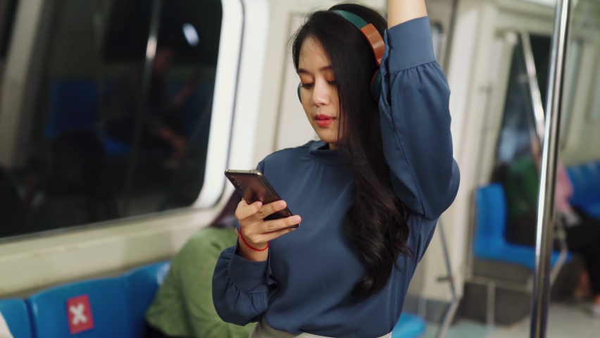 Young woman mobile phone on public train . Urban city lifestyle commuting concept . | Shutterstock HD Video #1061480590