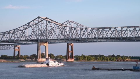 Barge passing the Crescent City Connection Bridge on the Mississippi River, New Orleans, Louisiana.