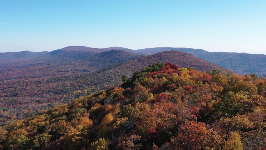 An aerial shot of Tibbet Knob and Great North Mountain in Autumn. The mountain range is the border between Virginia and West Virginia. The Trout Run Valley is also seen. Royalty-Free Stock Footage #1061498155