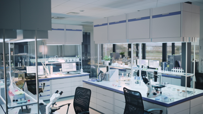 Modern Empty Biological Applied Science Laboratory with Technological Microscopes, Glass Test Tubes, Micropipettes and Desktop Computers and Displays. PC's are Running Sophisticated DNA Calculations. Royalty-Free Stock Footage #1061506288