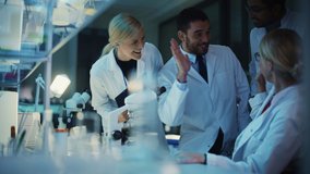 Surprized Female Reseach Scientist Makes an Important Discovery While Researching Samples Under the Microscope. Happy Colleagues Give High Five and Share Success with Fellow Bioengineers. - Powered by Shutterstock - Get 15% off with code: PIKWIZARD15