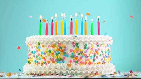 Birthday Cake With Burning Colorful Candles on Pastel Blue Background. Super Slow Motion, 1000 FPS.