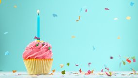 Birthday Cake With Burning Colorful Candle on Pastel Blue Background. Super Slow Motion, 1000 FPS. - Powered by Shutterstock - Get 15% off with code: PIKWIZARD15