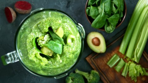 Green fresh smoothie blended in blender, top view. Healthy eating concept. Super slow motion filmed on high speed cinematic camera.