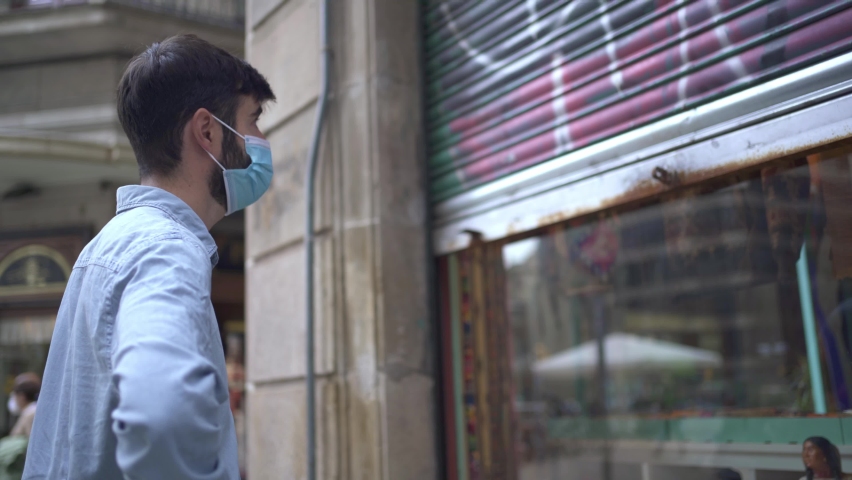 Young business man with mask closing a small local store door during the coronavirus crisis
 | Shutterstock HD Video #1061517004