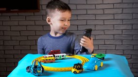 Video call of little boy playing with small cars
