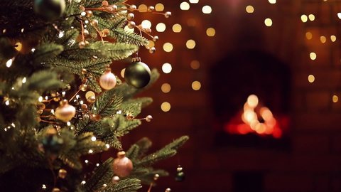Christmas Tree with Decorations and Gifts Near a Fireplace with Lights