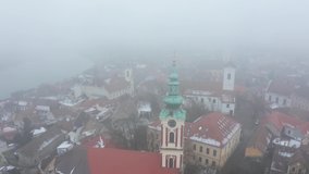 Beautiful small european town in the mystical fog. Szentendre, Hungary, Europe 4K aerial stock video. 