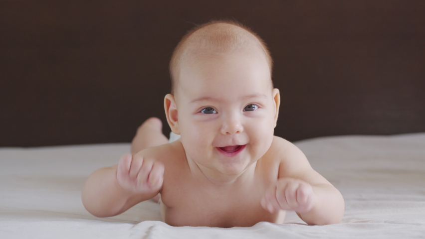Close up slow motion of lovely little baby girl smile indoor portrait of infant smile. | Shutterstock HD Video #1061529931