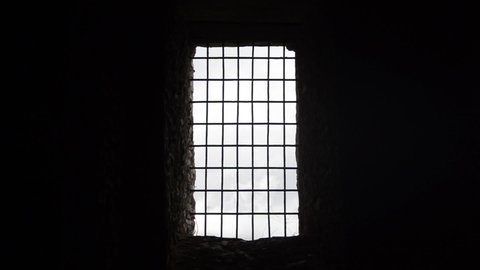 Metal bars in jail. Medieval prison with iron bars. Security grids in Dungeon. Prisoner view. Rods on a locked gate in castle. Barred doors in dungeon. Security grille as protection