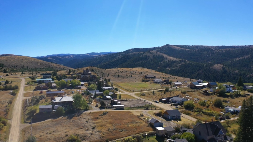 Aerial-Pulling back from view of small town in the mountains of Southwest Montana to the cemetery on a hill overlooking the historic mining town of  Virginia City, Montana