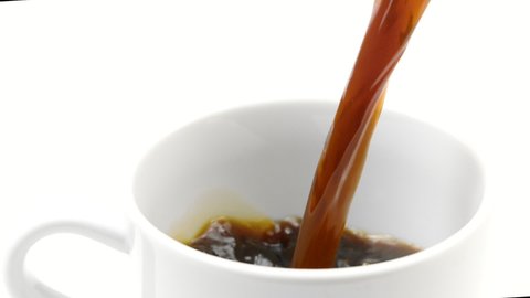 Fresh black coffee pouring into empty cup on white background in slow motion, close-up. Hot morning energy drinks or dark liquid, coffee break, espresso health benefits, americano, breakfast concept