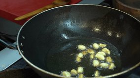 Footage garlic are fried in a pan. Video