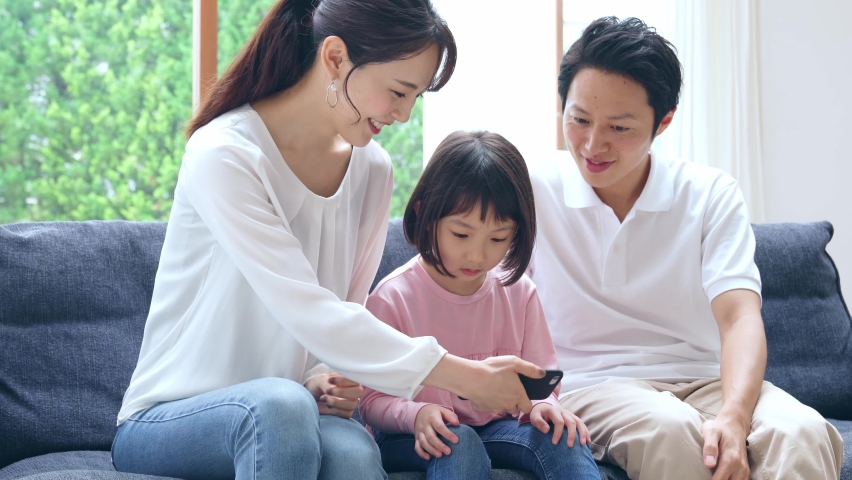 Family using a smart phone. Royalty-Free Stock Footage #1061542843