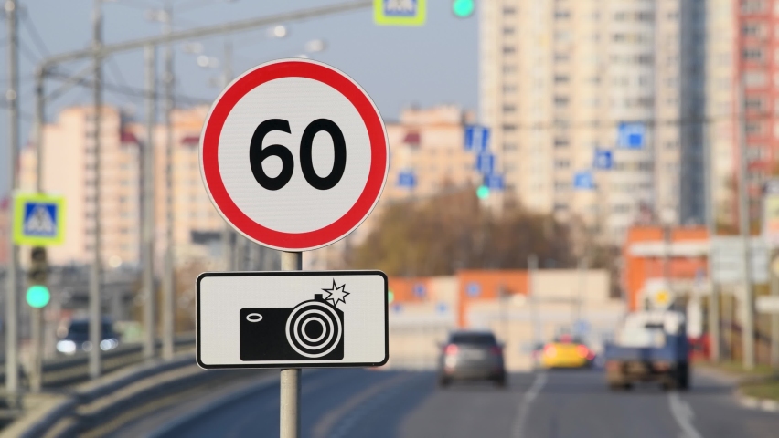 60 km per hour speed limit sign with radar control against car traffic on a city highway Royalty-Free Stock Footage #1061545525