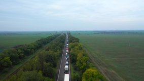 Aerial view of the huge traffic jam on the highway due to an accident. Drone flying over the highway. Ukrainian nature from above