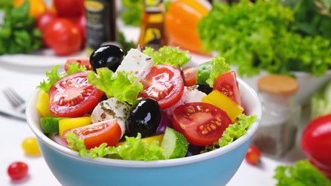 Fresh vegetable salad, mediterranean cuisine ingredients, greek salad, white table served with healthy food