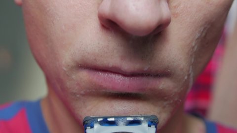 Shaving facial skin macro closeup of man point of view camera movement