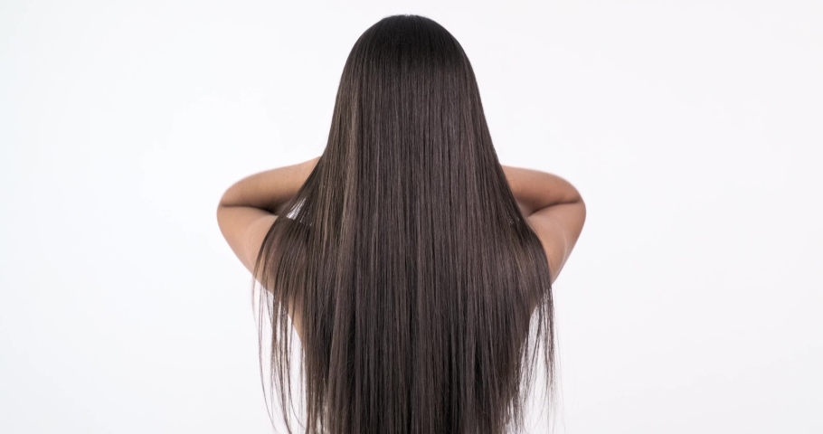 Woman moves long hair. Rear view. Girl shakes long straight hair. Slow motion footage. Rear view. 4k. Female model is fluttering hair.  | Shutterstock HD Video #1061563477
