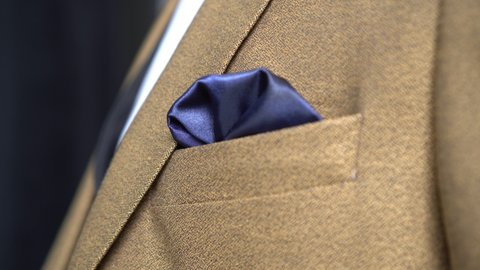 Male classic suit and a handkerchief in a jacket pocket close-up. Businessman, men's fashion.