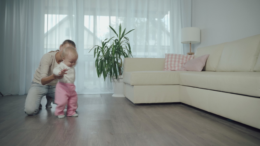 Mother Woman Teaches Child How to Take First Steps Walking Home