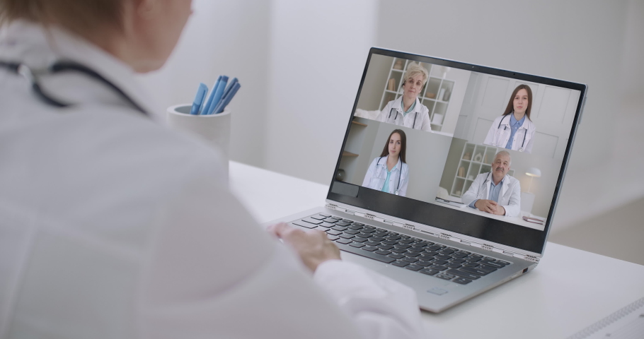 Close up of young female talk on video call consult with diverse doctors colleagues, woman patient have online consultation with GP or physicians, medical nurse in Webcam conference with coworkers Royalty-Free Stock Footage #1061571460