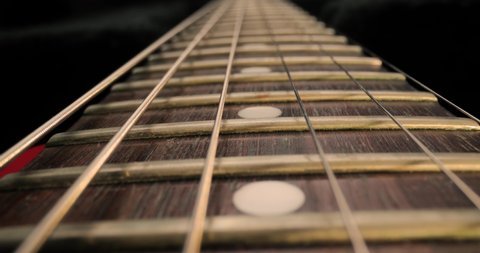 Electric guitar fretboard macro closeup slider shot