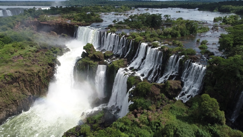 Panoramic landscape of nature waterfalls. Aerial landscape of Iguazu waterfalls. Niagara waterfalls. Cataratas del Iguazu waterfall. Waterfalls nature scene. Rainbow water falls landscape. Waterfall Royalty-Free Stock Footage #1061575222