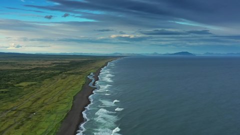 Aerial view of estuary on Khalaktyrsky beach with black sand and volcano on Kamchatka peninsula, Russia, Pacific ocean