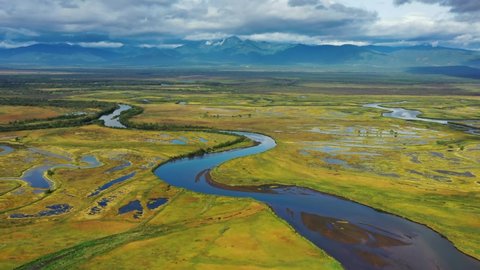 Aerial view of Avacha river delta and hilly landscape, Kamchatka Peninsula, Russia, 4k