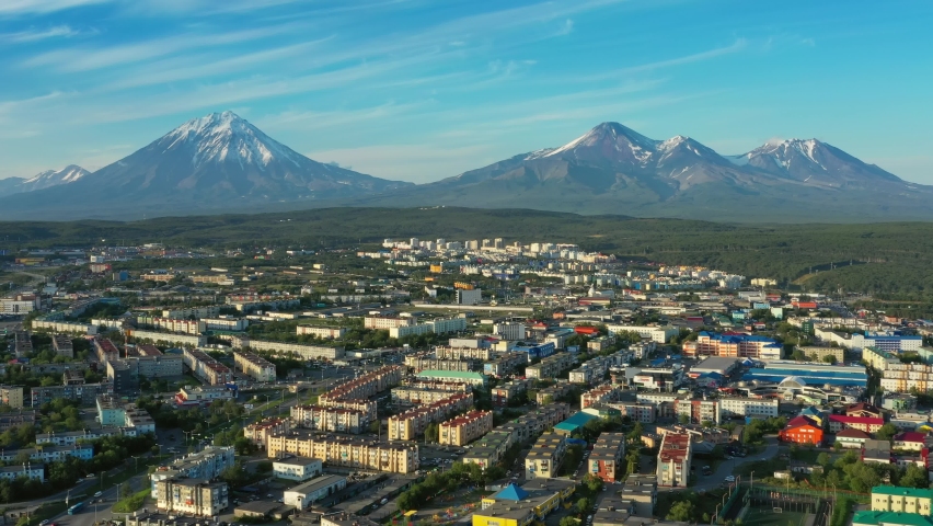 Flying over Petropavlovsk-Kamchatsky city at sunset and cone of volcano. Kamchatka Peninsula, Russia, 4k | Shutterstock HD Video #1061581102