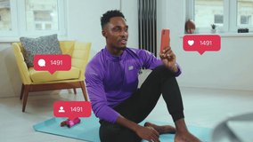African american young man after training have video call smile feel happy at home. Social media icons with like comment follower counter in light room. Chatting online. Slow motion - Powered by Shutterstock - Get 15% off with code: PIKWIZARD15