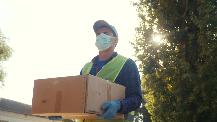 courier delivery man covid delivers food to your home. parcel delivery concept.  Royalty-Free Stock Footage #1061588917