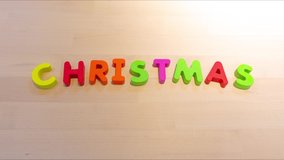Merry Christmas text stop motion animation, jumping words for holiday concept. Social media footage. Family holiday decoration creative image. Descriptive seamless looping video for b-roll or title