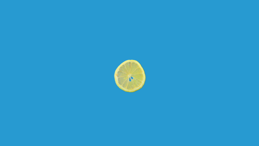 lemon slice spinning around in loop motion isolated on blue background Royalty-Free Stock Footage #1061594218